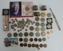 A collection of coins, hallmarked silver napkin rings, letter opener etc