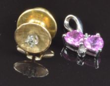 A 9ct white gold pendant set with heart cut pink sapphires and diamonds and a yellow metal pin set