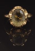 A 9ct gold ring set with an oval cut smoky quartz, size N, 3.4g