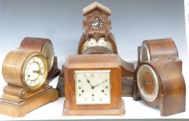 Six C1920-1930 mantel clocks and a 1970s cuckoo wall clock, includes a drum cased Wurttemberg