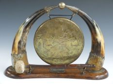 Dinner gong flanked by horns, width 37cm