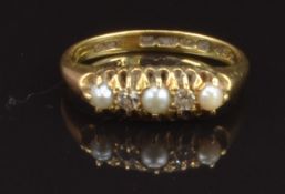 An 18ct gold ring set with diamonds and pearls, Birmingham 1914, size M, 3.3g