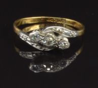 An 18ct gold ring set with three diamonds in a platinum setting, size L, 2.3g