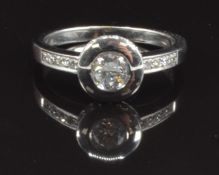 An 18ct white gold ring set with a round cut diamond of approximately 0.4ct and with diamond set