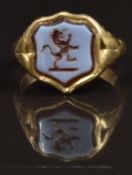 An 18ct gold signet ring set with a carved agate section, size P, 8g