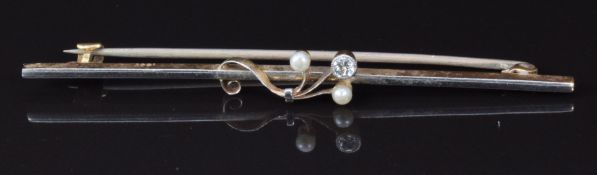 A 15ct gold brooch set with a diamond and two seed pearls with a platinum finish, 5.8cm, 2.9g