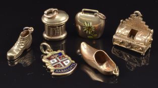 Six 9ct gold charms including post box, boot, clog, bell and 'Harrogate' enamel charm, 9.4g