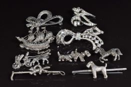 Four silver brooches set with marcasite, a silver brooch in the form of an Airedale dog and other