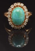 Early 19thC yellow metal ring set with a turquoise cabochon surrounded by diamonds, size K, 4.5g