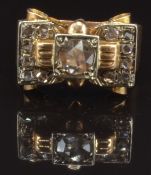 Art Deco ring set with rose cut diamonds in a stylised bow setting, the central diamond