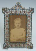 Gilt metal photograph frame set with garnets, opals and turquoise stones c1900, in the Russian or