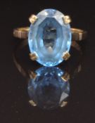 A 9ct gold ring set with an oval cut blue topaz, size S, 5.8g