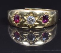 An 18ct gold ring set with a diamond and rubies, 2.5g