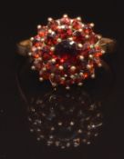 A 9ct gold ring set with a cluster of garnets, size Q, 2.9g