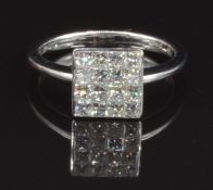 An 18ct white gold ring set with approximately 0.75ct of square cut diamonds, size N, 3.6g