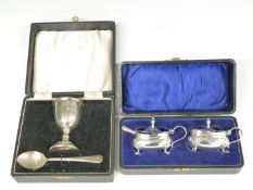 Pair of hallmarked silver mustards with blue glass liners and hallmarked silver spoon, together with