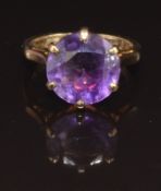 A 9ct gold ring set with a round cut amethyst, 4.1g