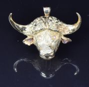 An 18ct gold pendant in the form of a Cape buffalo set with diamond eyes, by Franz Hirner, 4 x