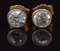 A pair of 18ct gold earrings each set with a diamond of approximately 0.5ct