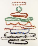 A group of necklaces including three coral, jet, Czech and other glass examples etc