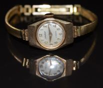 Victor 9ct gold ladies wristwatch with gold hands and Arabic numerals, silver dial, bevelled case