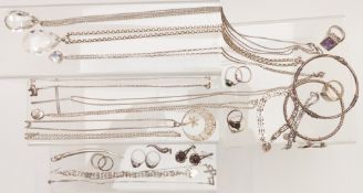 A collection of silver jewellery including pendants, two bangles, nine rings, earrings, necklaces,