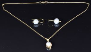 An 18ct gold pendant set with a pearl and diamond, 4.9g, and a pair of yellow metal earrings set
