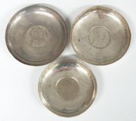Three coin based pin dishes, one with feature hallmarks the other two unmarked, diameter of