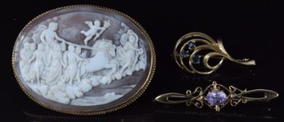 A 9ct gold brooch set with a cameo depicting a classical scene, a 9ct gold brooch set with sapphires