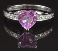A 14k white gold ring set with a pink heart cut sapphire and diamonds, size M, 2.8g