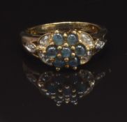 A 9ct gold ring set with round Alexandrite cabochons and diamonds in a cluster, size N, 3.7g