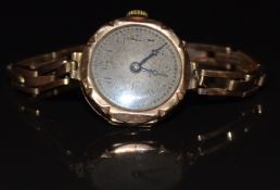 Unnamed 9ct gold ladies wristwatch with blued hands, black Arabic numerals, silver dial and 15 jewel