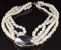A four strand cultured pearl necklace with large silver slider