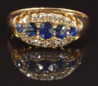 An 18ct gold ring set with oval cut sapphires and diamonds, Birmingham 1909, size M, 3.1g