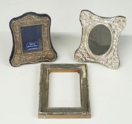 Three various hallmarked silver photograph frames, two having embossed decoration and easel backs,