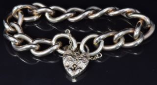 A 9ct gold curb link bracelet with engraved heart padlock clasp, 72g