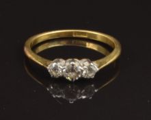 An 18ct gold ring set with three diamonds, size K, 2g