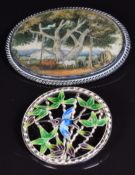A silver brooch set with a painted ivory plaque and a silver brooch set with enamel