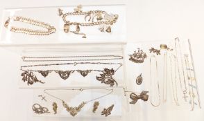 A group of silver jewellery including charm bracelet, curb link bracelet, chains, necklace, brooches