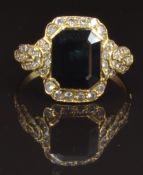 An 18ct gold ring set with an emerald cut sapphire and diamonds, size O, 3.9g