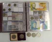 An amateur collection of UK and world coins and banknotes in a collector's folder, together with a