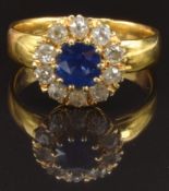 A 22ct gold ring set with a cushion cut sapphire of approximately 0.65ct surrounded by old cut