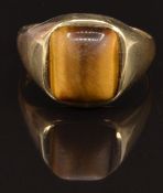 A 9ct gold ring set with a tiger's eye cabochon, size T, 4.8g