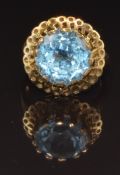 A 9ct gold ring set with a round cut blue topaz, size N, 6.7g