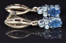 A pair of 9ct gold earrings set with an oval sapphire and diamonds, 2.8g