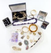 A collection of jewellery including brooches, amethyst necklace, filigree ring, silver bracelet, etc