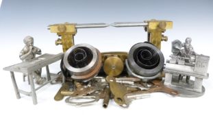 Clock keys, depthings tool springs etc together with pewter figures depicting repairers and clock