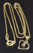 An 18ct gold pendant set with a ruby on an 18ct gold chain, 3g, length 44cm
