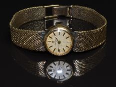 Omega 9ct gold ladies wristwatch with two-tone hands and baton hour markers, gold dial and signed 17