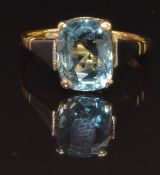 An 18ct gold ring set with a cushion cut aquamarine in a platinum setting, size N, 3.1g